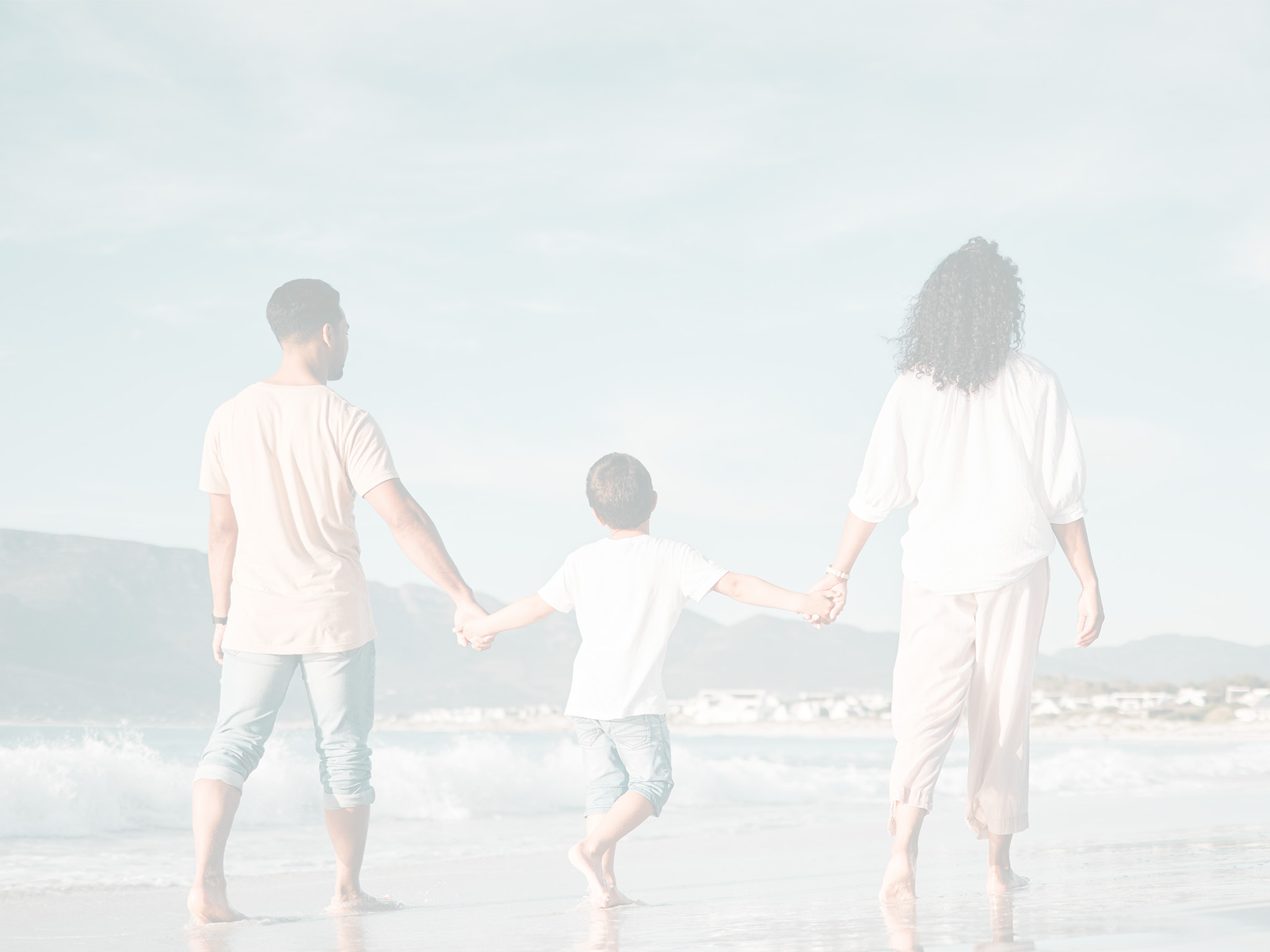 Family on the beach hand holding