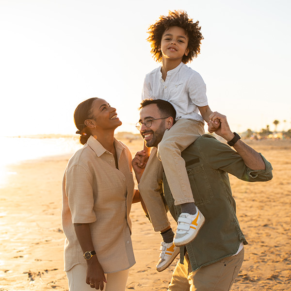 family laughing on beach